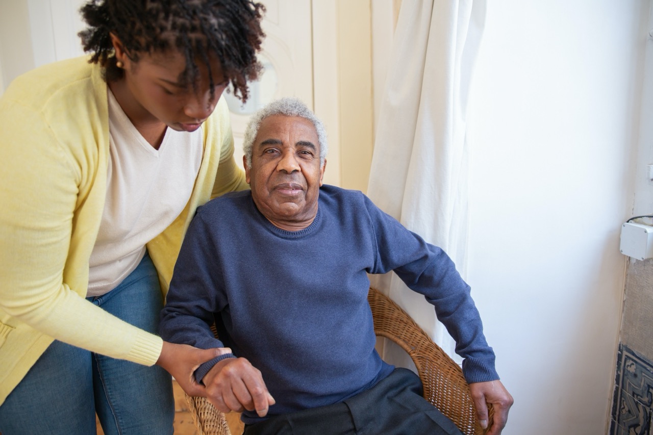 Professional caregiver assisting an elder